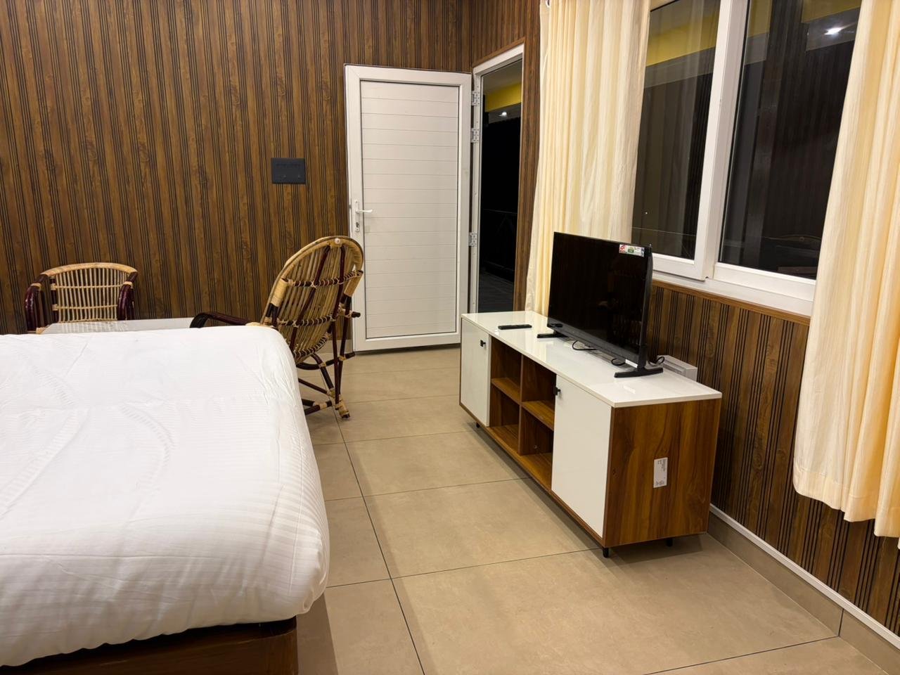 Bedroom with balcony access at Misty Meadows