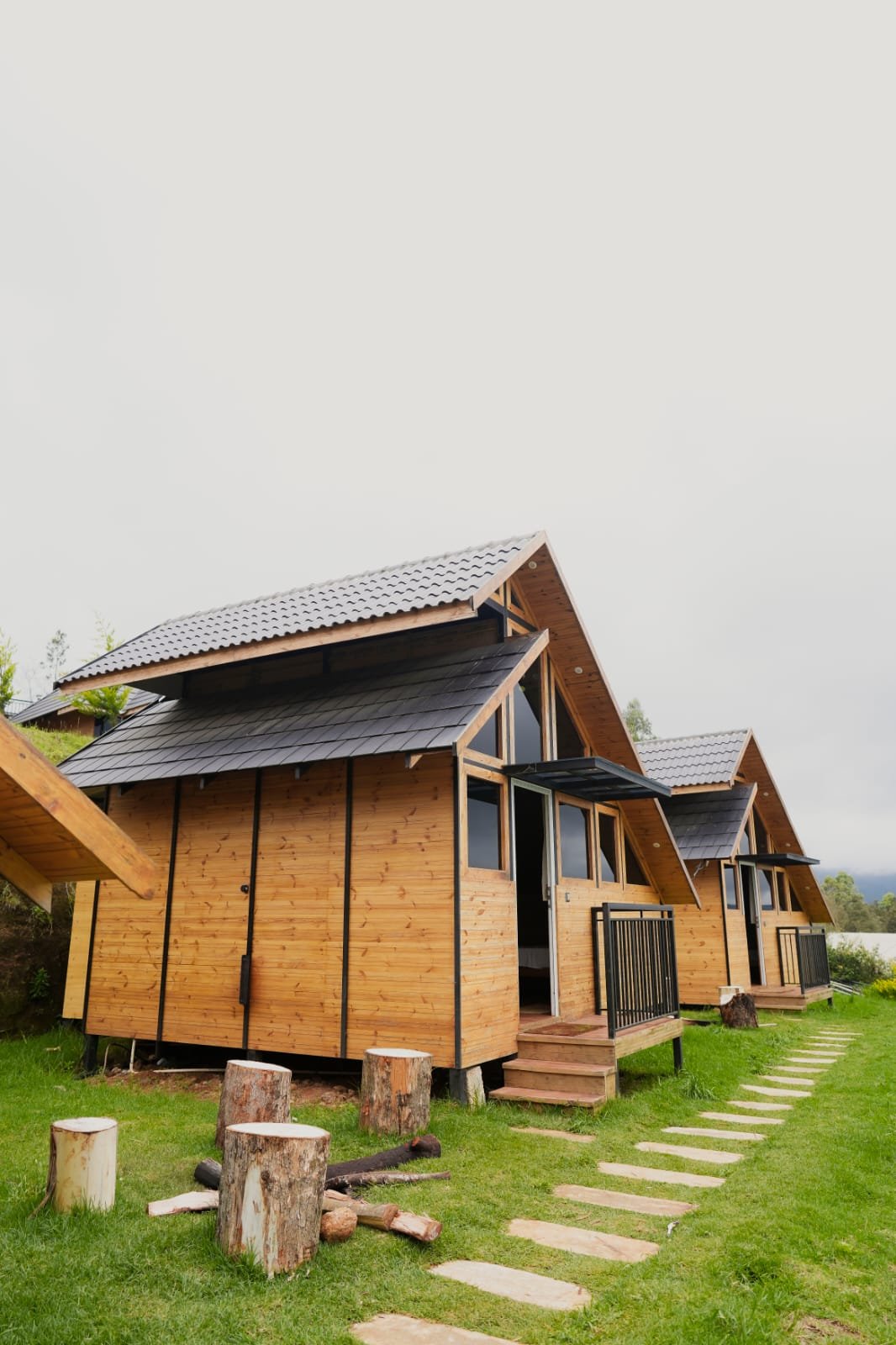 Wooden cottages and garden path at Misty Meadows