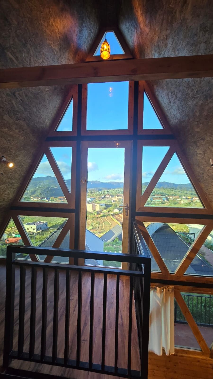 Valley view through the A-frame glass front at Misty Meadows