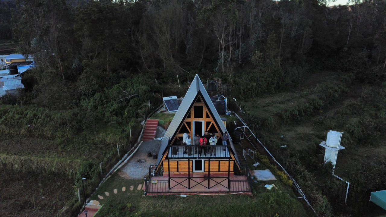 Aerial view of an A-frame cottage at Misty Meadows
