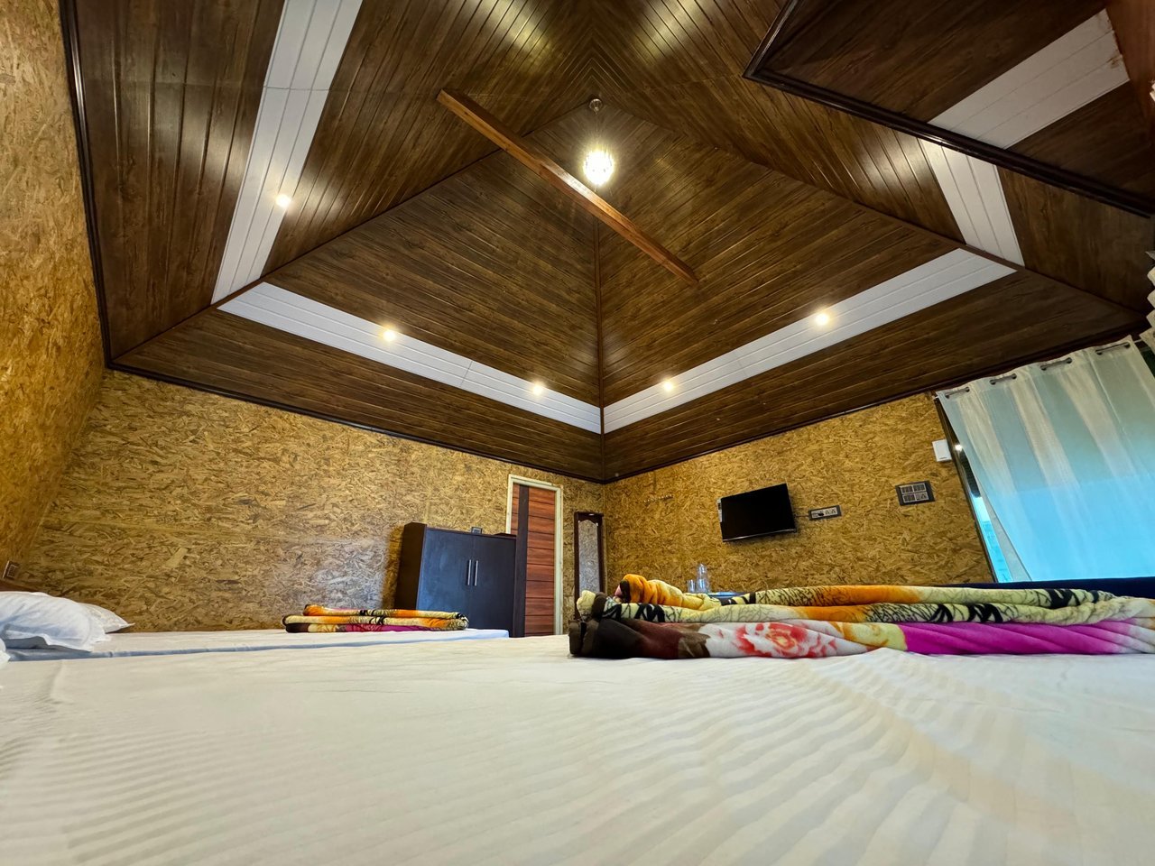 Bedroom with wooden tray ceiling at Misty Meadows