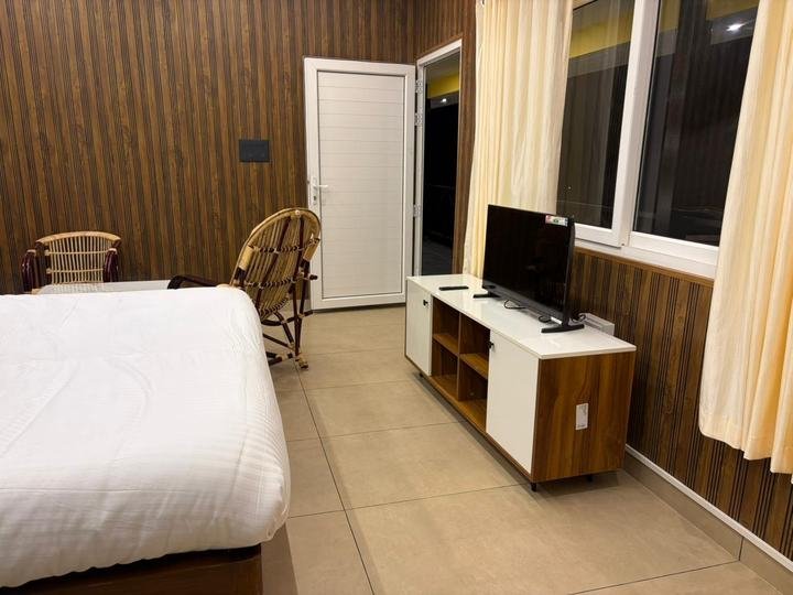 Bedroom with balcony access at Misty Meadows