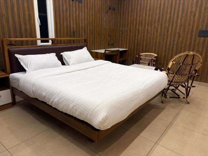 Double bedroom with cane rocking chair at Misty Meadows