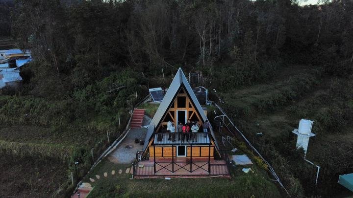 Aerial view of an A-frame cottage at Misty Meadows
