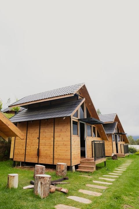 Wooden cottages and garden path at Misty Meadows